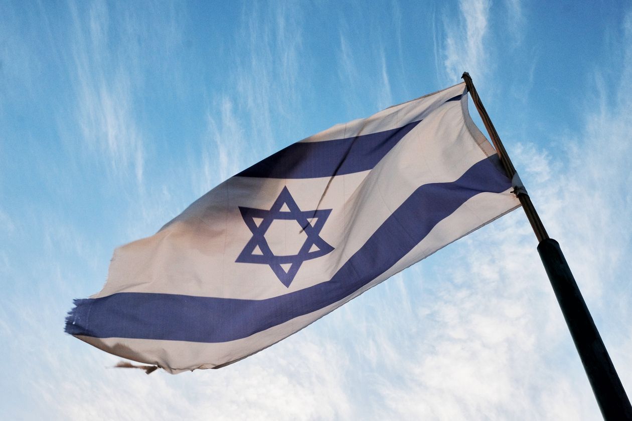 Israeli flag against a blue sky