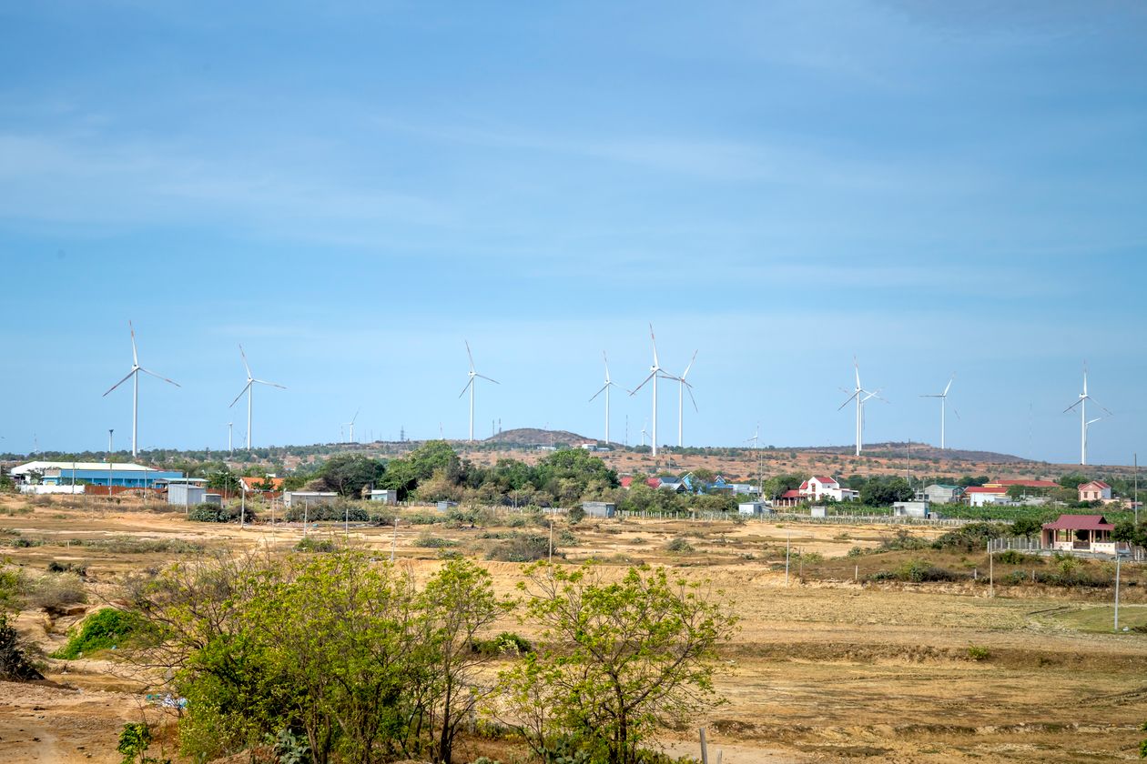 Wind turbines beneath a blue sky
