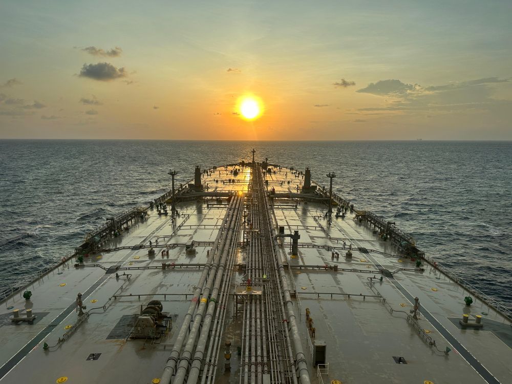 Oil tanker at sea at sunset