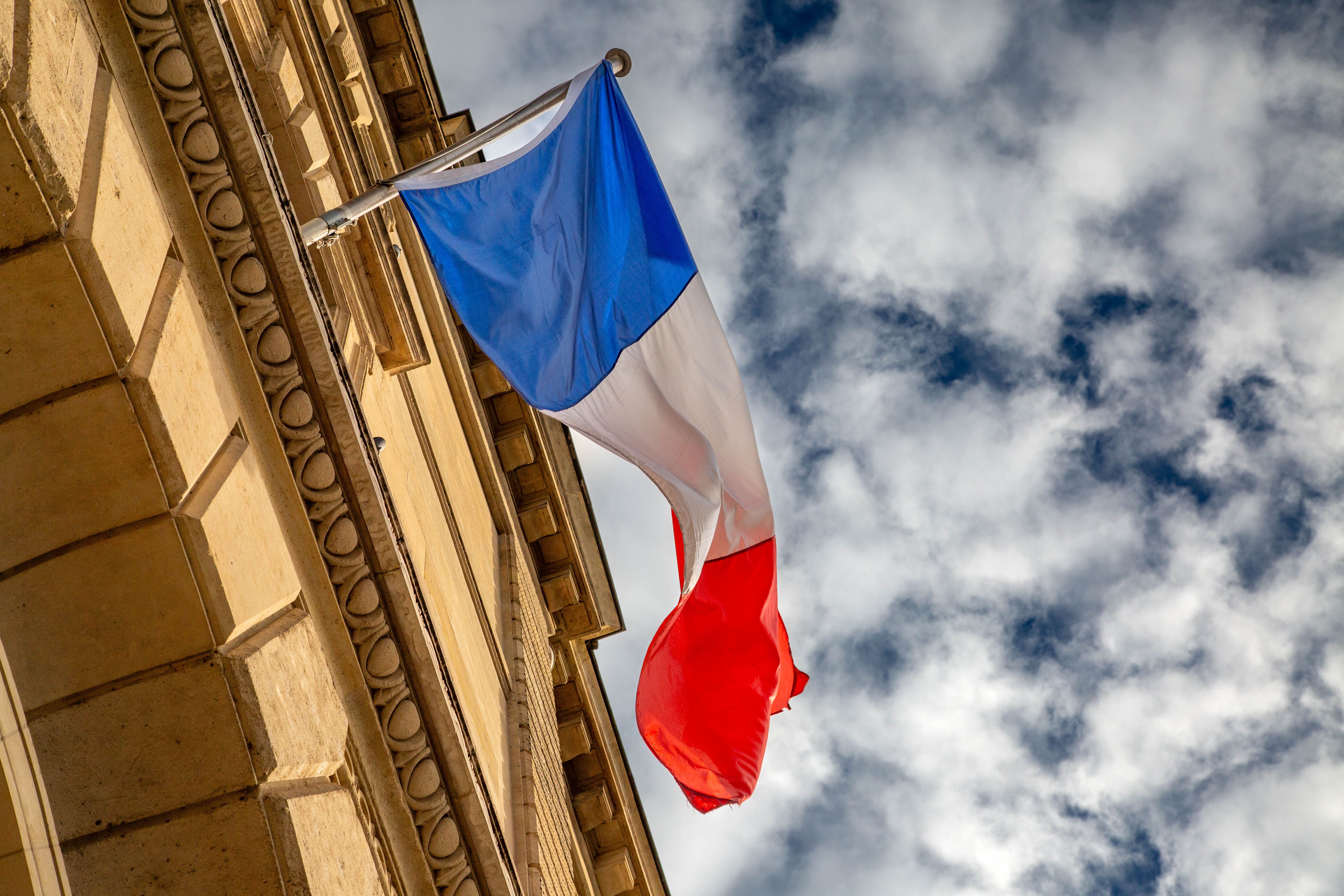 French flag on a Paris building; illustrative file photograph, not a protest scene